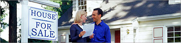 Couple in front of their house